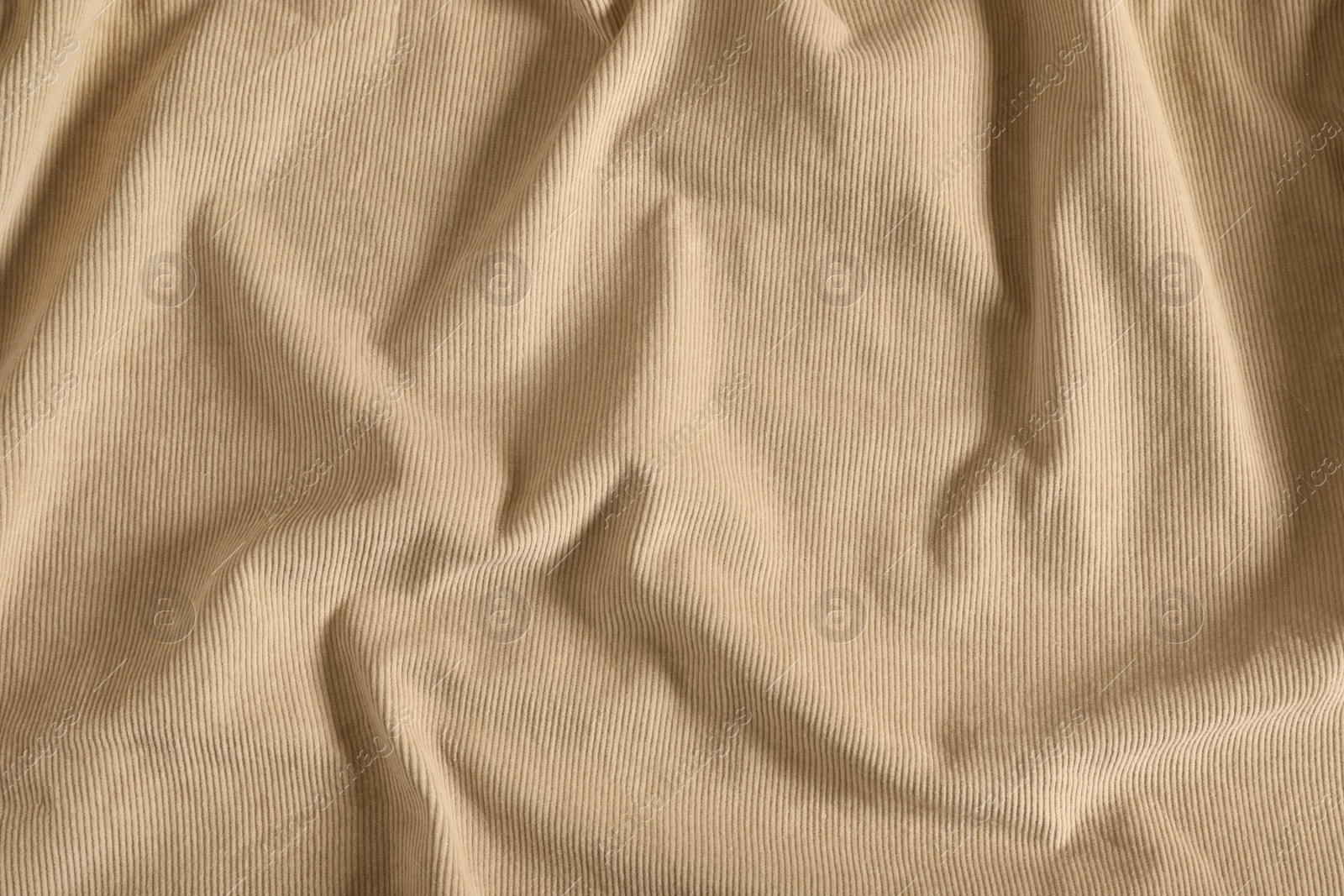 Photo of Crumpled beige fabric as background, top view