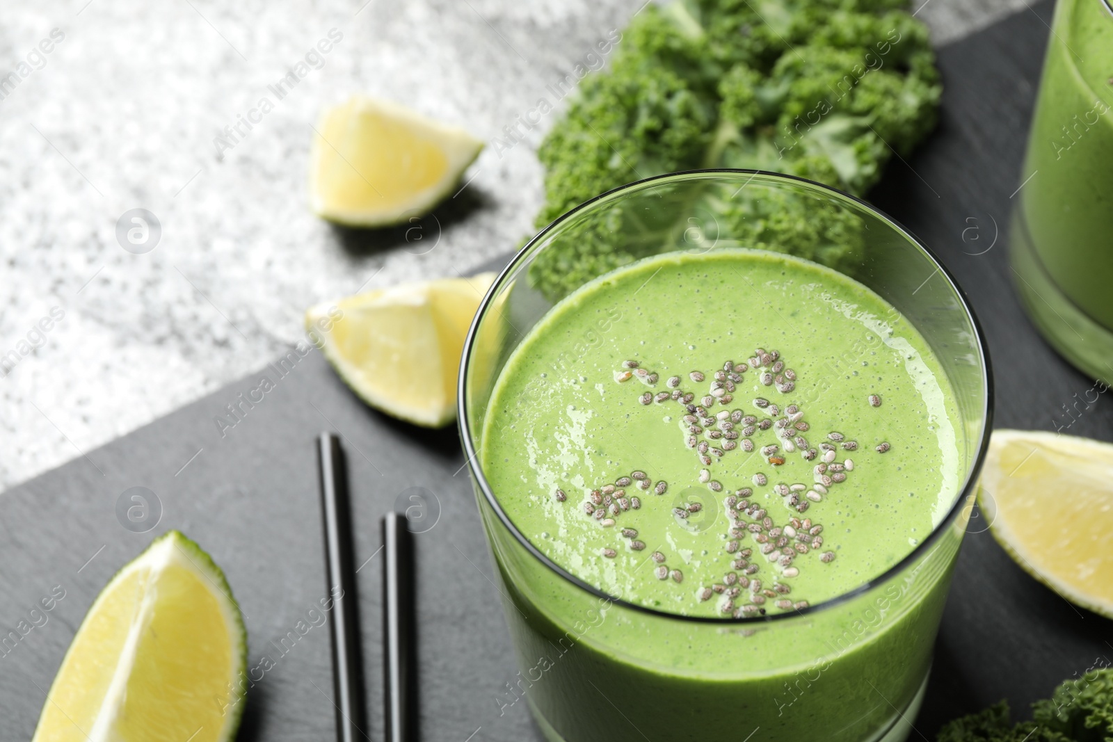 Photo of Tasty kale smoothie with chia seeds on table, closeup