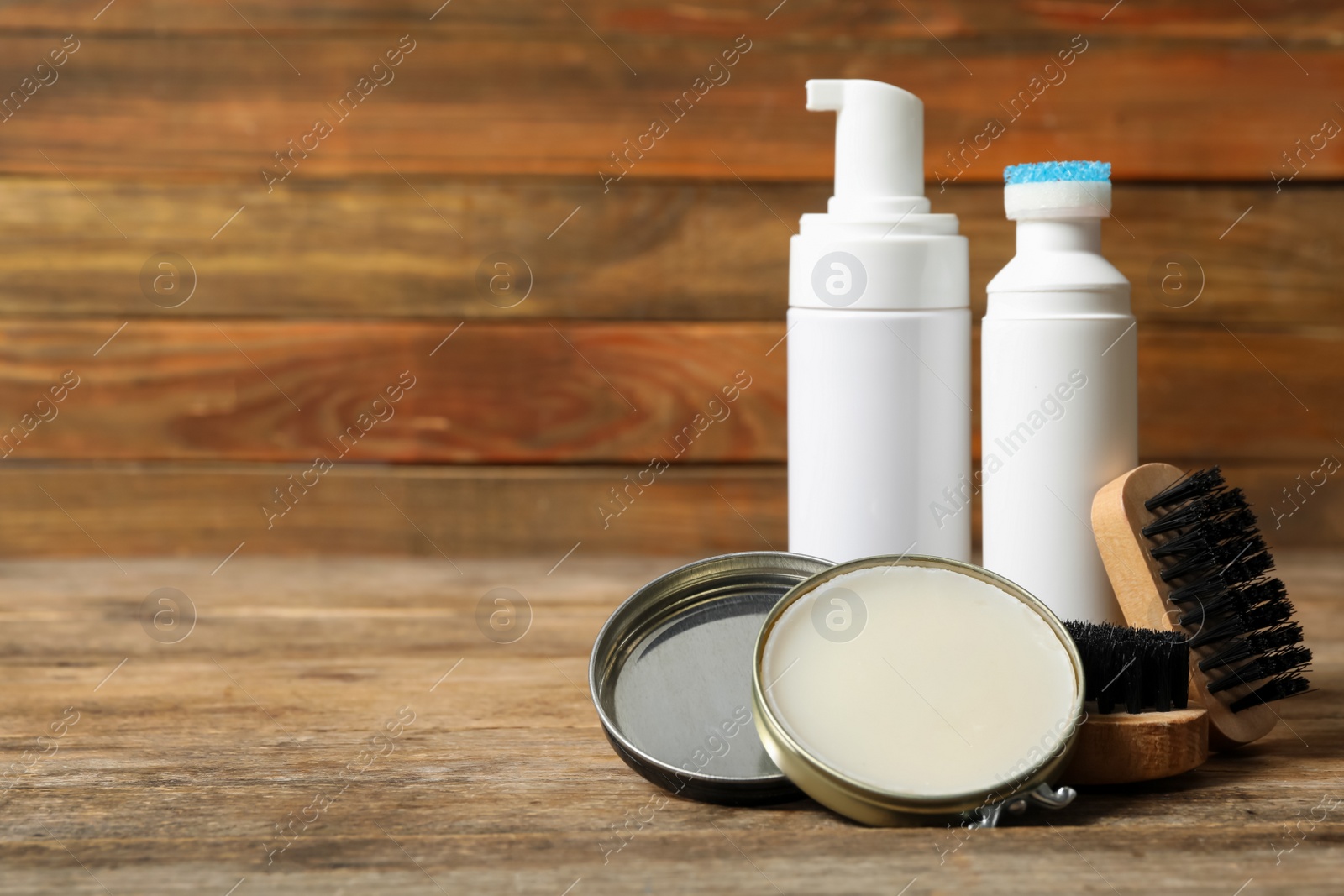 Photo of Composition with shoe care accessories on wooden table, closeup. Space for text