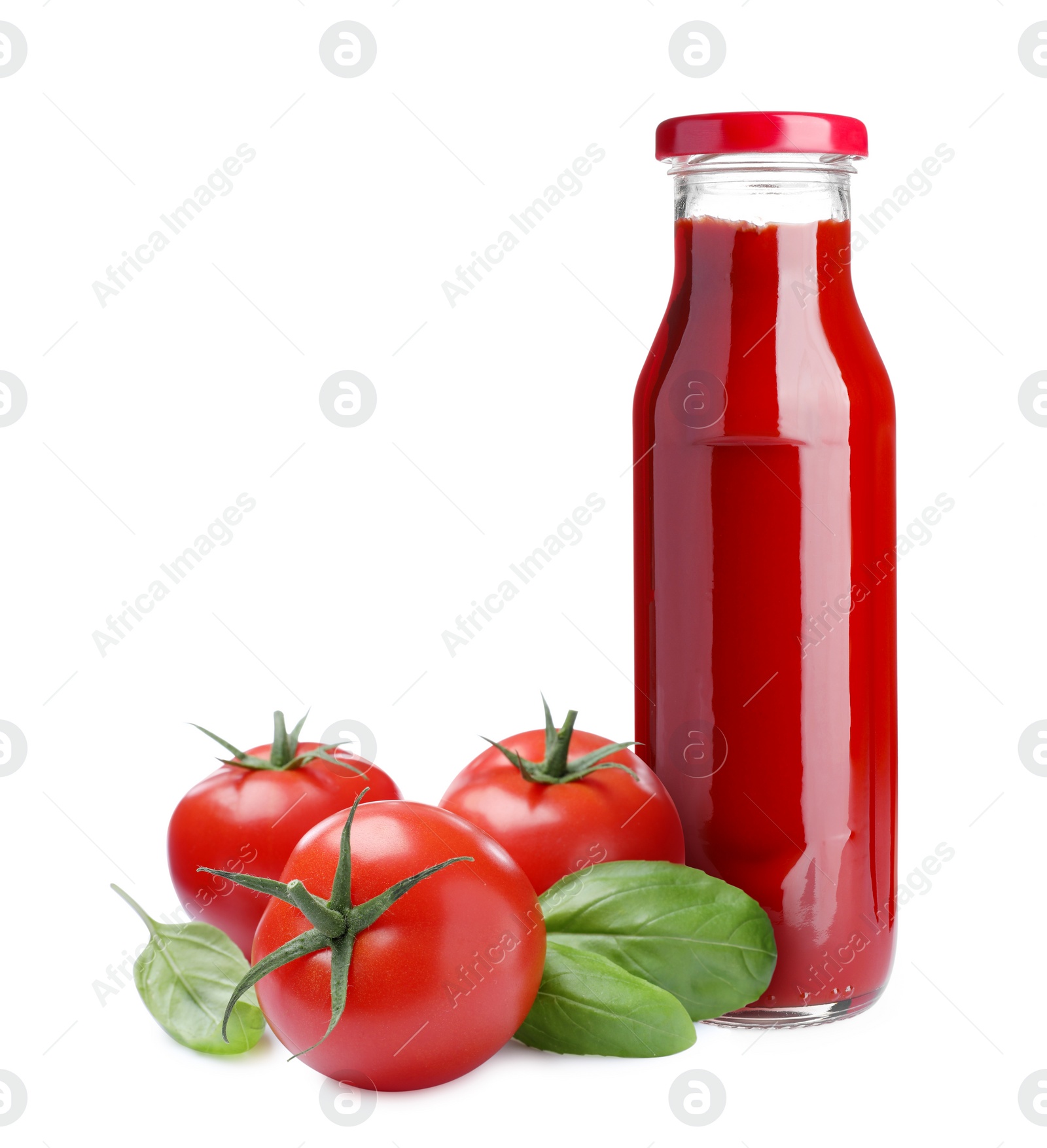 Image of Organic ketchup in glass bottle, fresh tomatoes and basil on white background