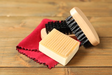 Photo of Composition with shoe care accessories on wooden background, closeup