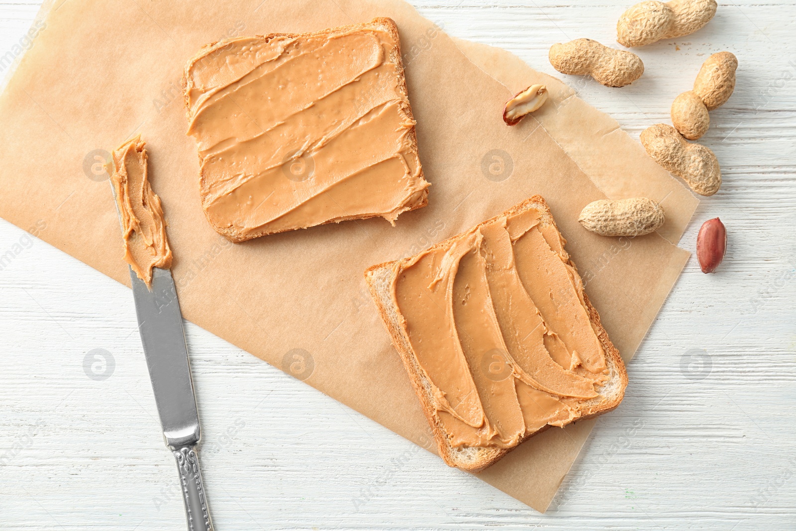 Photo of Tasty toasts with peanut butter on table