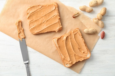 Tasty toasts with peanut butter on table