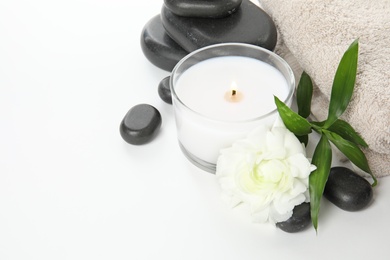 Photo of Beautiful spa composition with candle and stones on white background