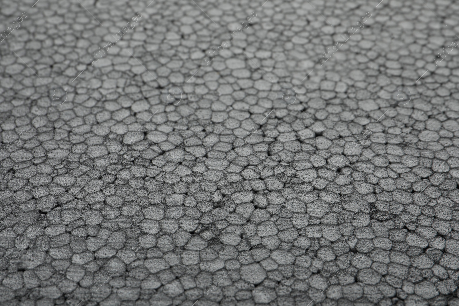 Photo of Texture of grey styrofoam sheet as background, closeup