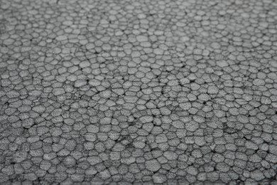 Texture of grey styrofoam sheet as background, closeup