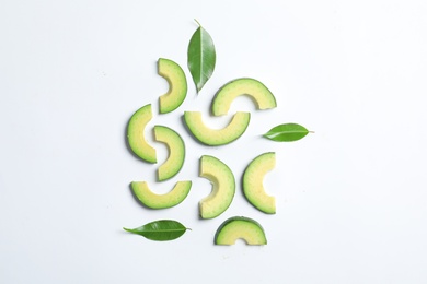 Photo of Composition with sliced ripe avocado on white background