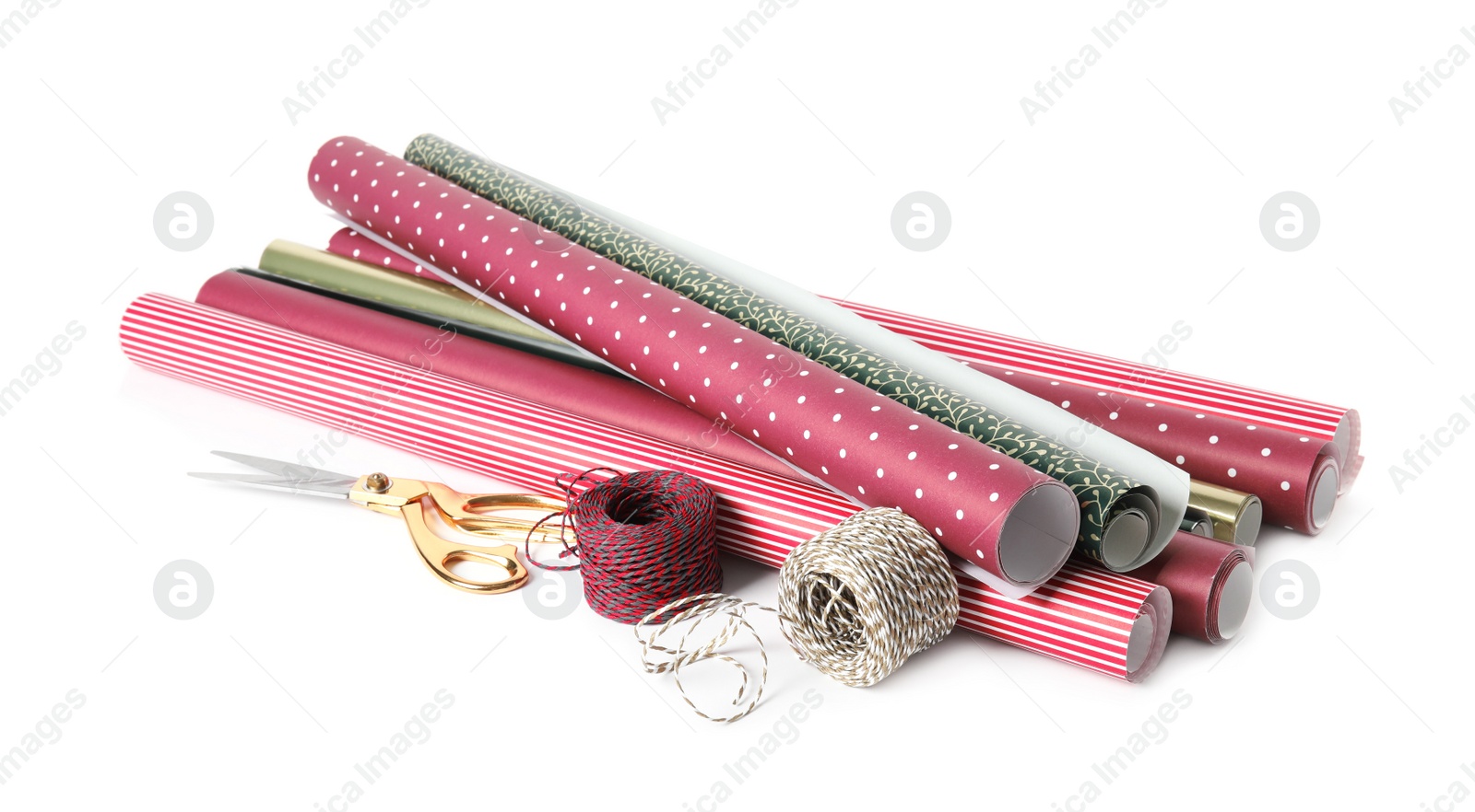 Photo of Different colorful wrapping paper rolls, scissors and ropes on white background