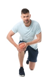 Photo of Full length portrait of sportsman having knee problems on white background