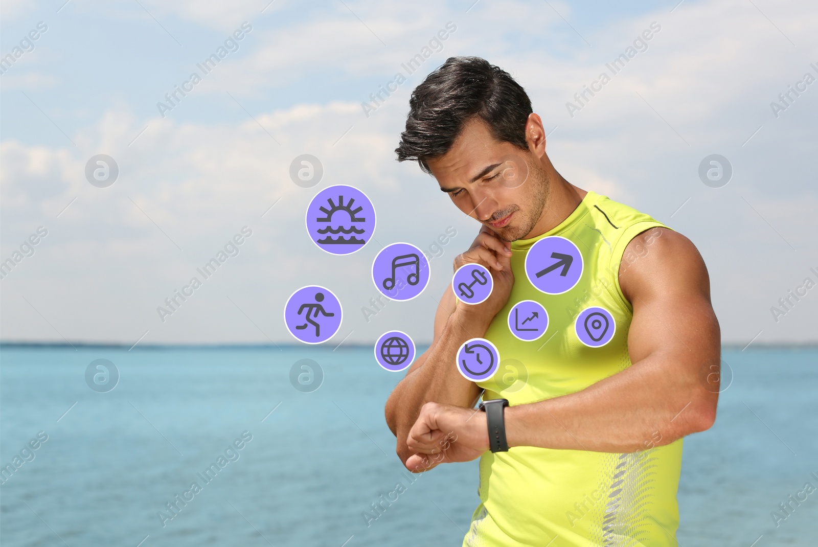 Image of Young man checking fitness tracker after training on beach