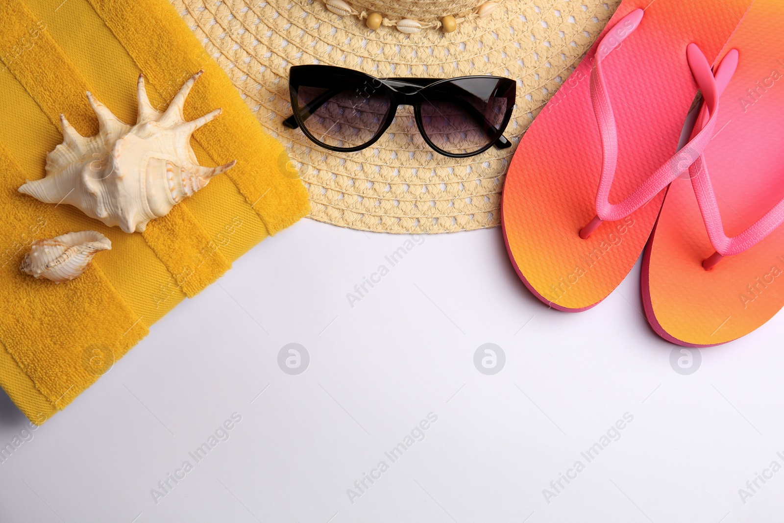 Photo of Flat lay composition with beach accessories on white background. Space for text