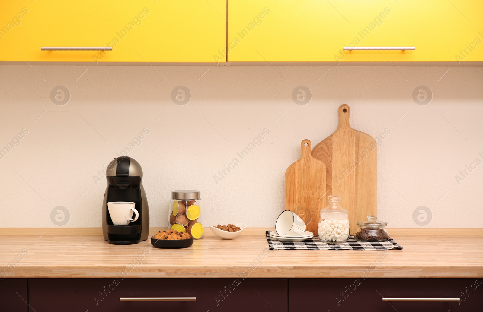 Photo of Modern coffeemaker on countertop near light wall in kitchen