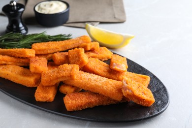 Photo of Tasty fresh fish fingers served on white table
