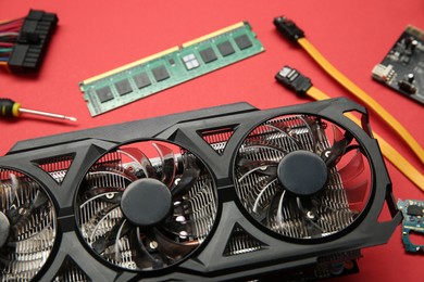 Photo of Graphics card and other computer hardware on red background, closeup