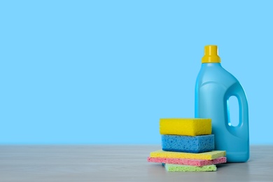 Photo of Bottle of cleaning product and supplies on light table. Space for text