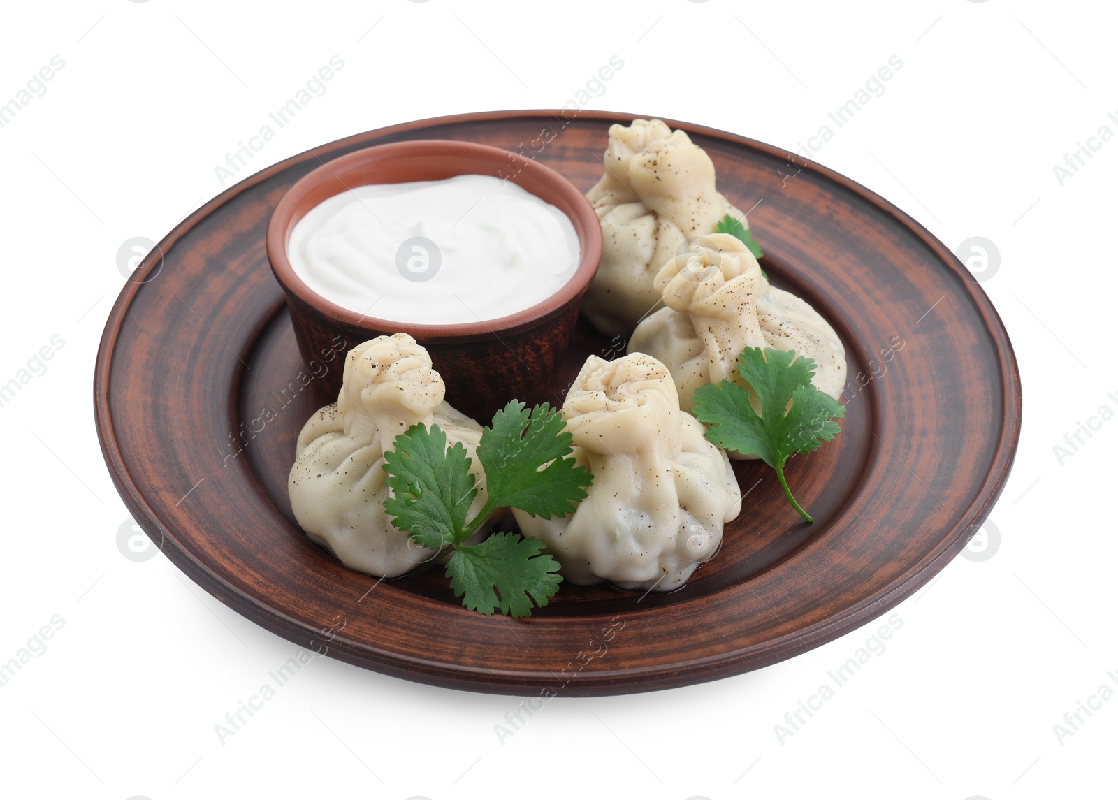 Photo of Tasty khinkali (dumplings) with sauce and spices isolated on white. Georgian cuisine