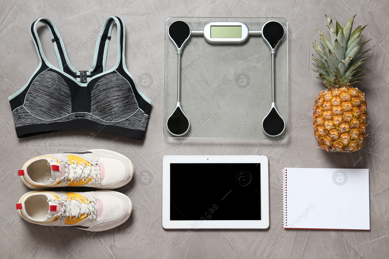 Photo of Flat lay composition with sport equipment and scales on gray background. Weight loss