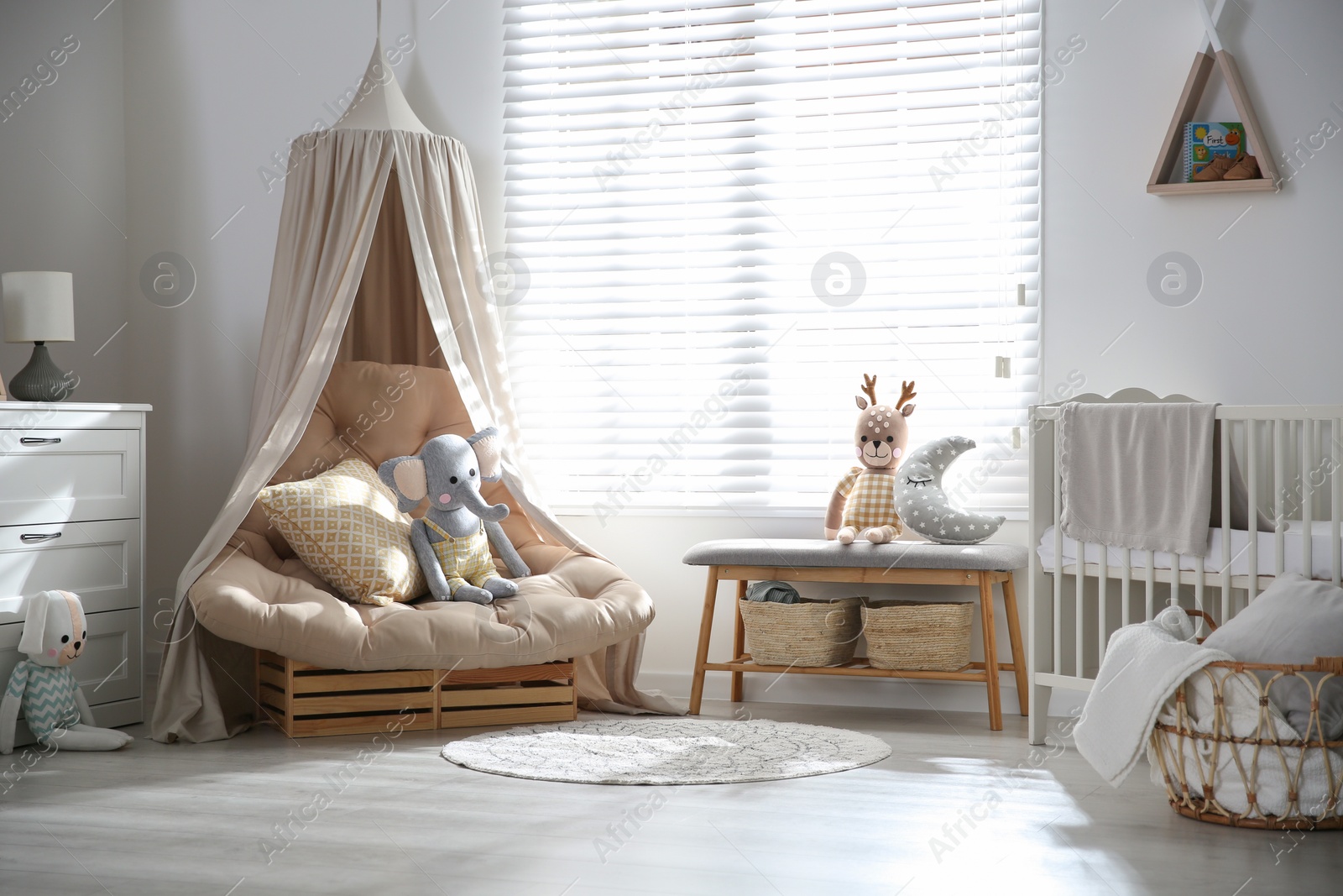 Photo of Comfortable armchair in modern baby room interior