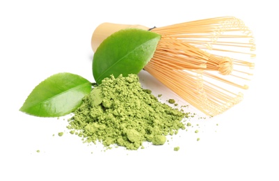 Photo of Matcha tea, green leaves and bamboo whisk on white background