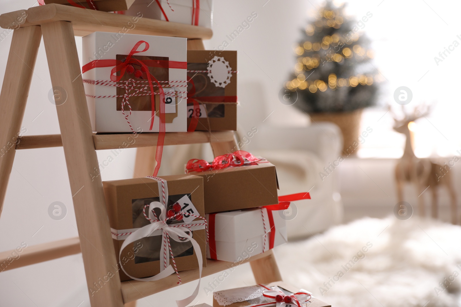 Photo of Advent calendar with gifts in room decorated for Christmas, closeup. Space for text