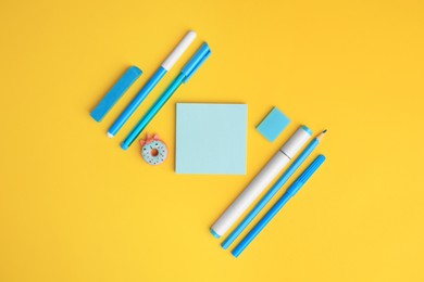 Photo of Flat lay composition with different school stationery on yellow background, space for text. Back to school