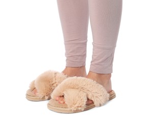 Photo of Woman in beige fluffy slippers on white background, closeup