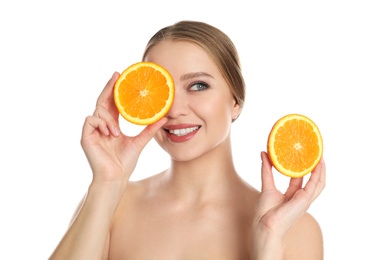 Photo of Young woman with cut orange on white background. Vitamin rich food