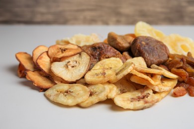 Pile of different dried fruits on white background, closeup