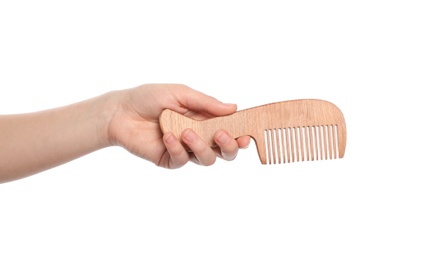 Photo of Woman holding wooden hair comb on white background, closeup