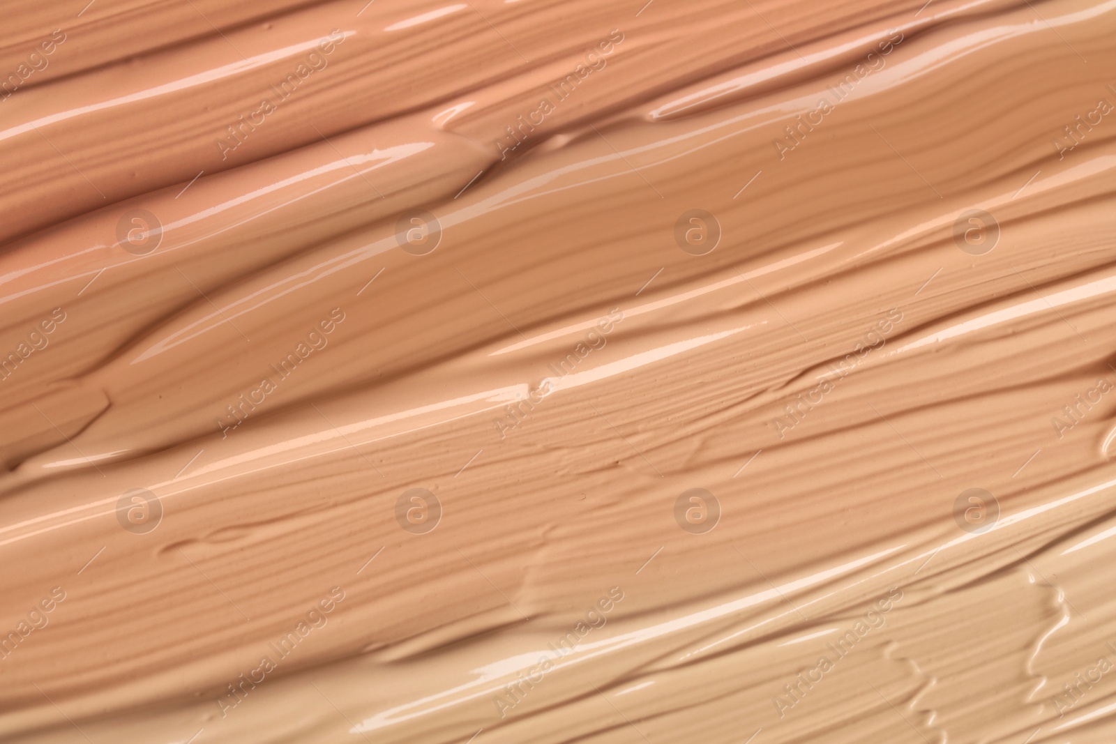 Image of Different shades of liquid foundation as background, closeup