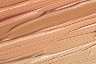 Different shades of liquid foundation as background, closeup