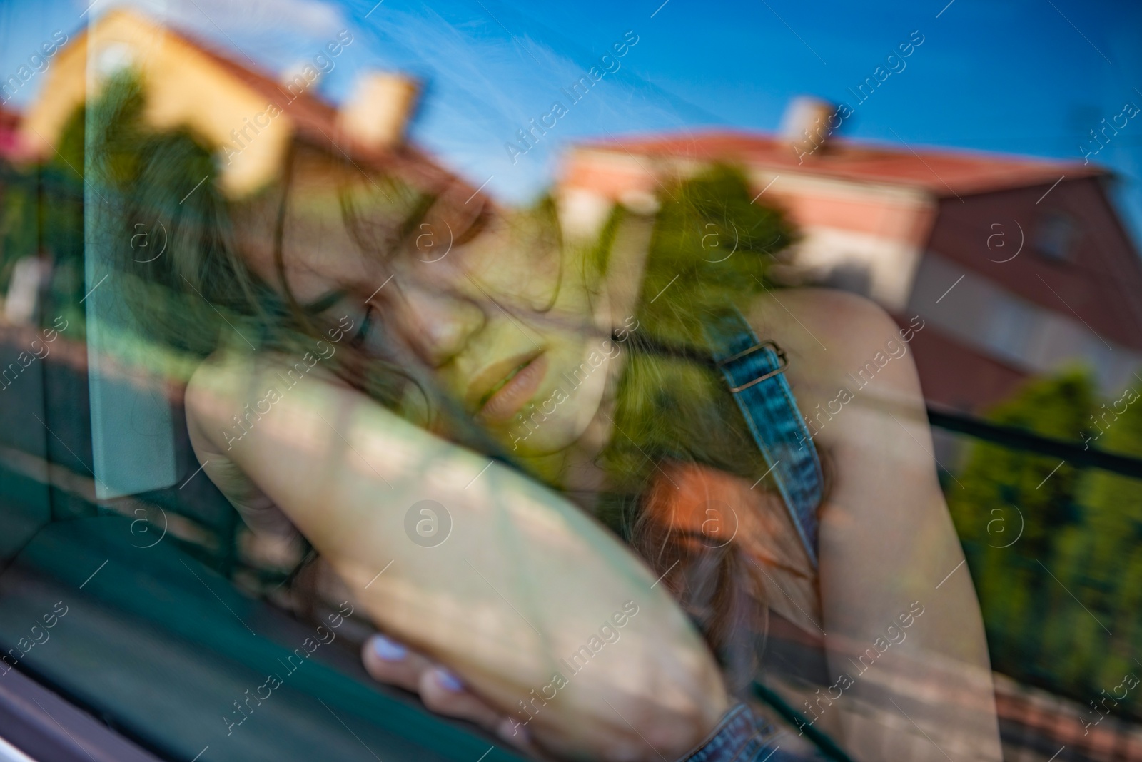 Photo of Tired girl sleeping in car, view from outside