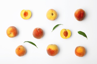 Composition with fresh sweet peaches on white background