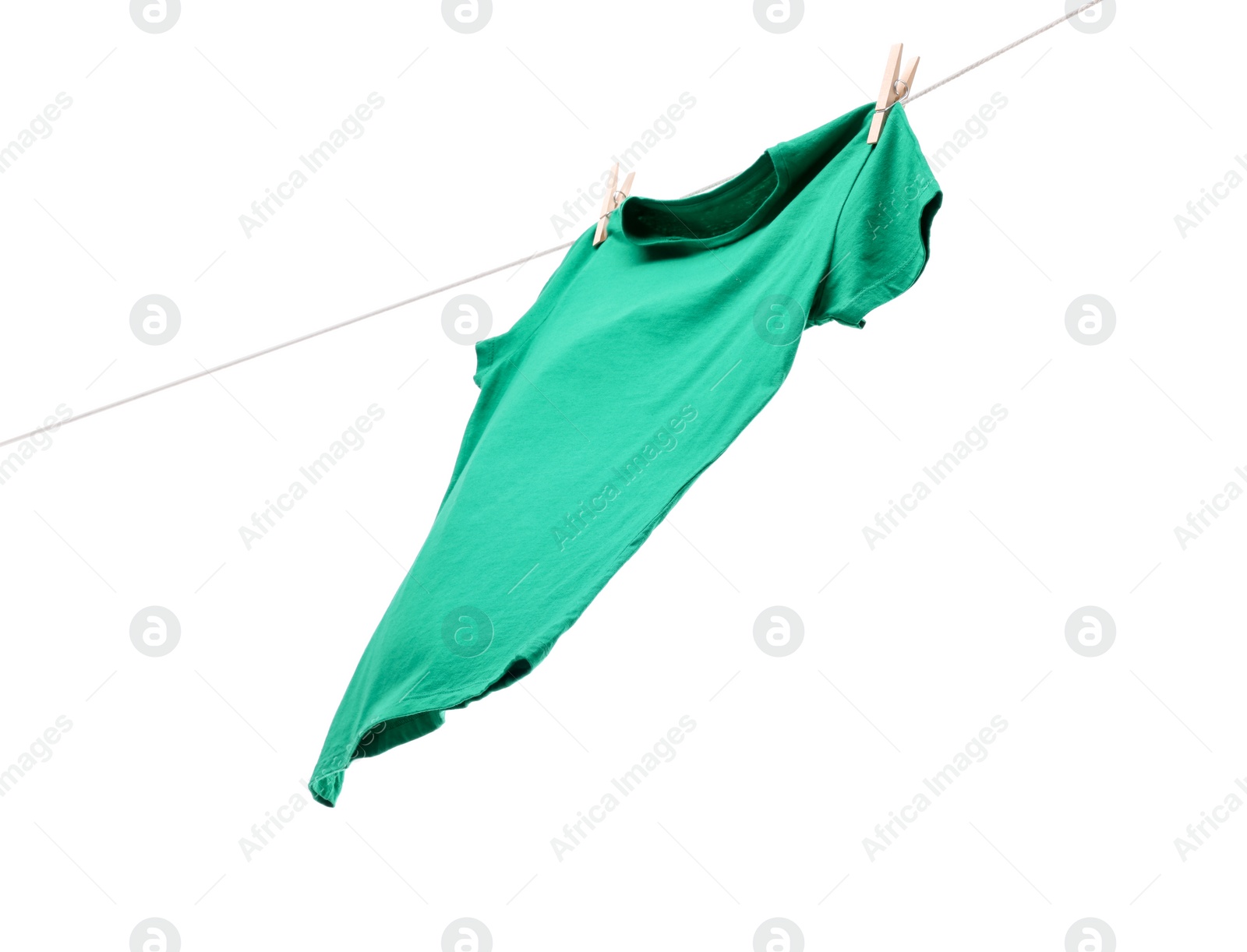 Photo of One green t-shirt drying on washing line isolated on white