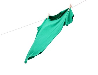 One green t-shirt drying on washing line isolated on white