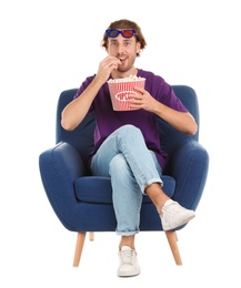 Photo of Man with 3D glasses and popcorn sitting in armchair during cinema show on white background