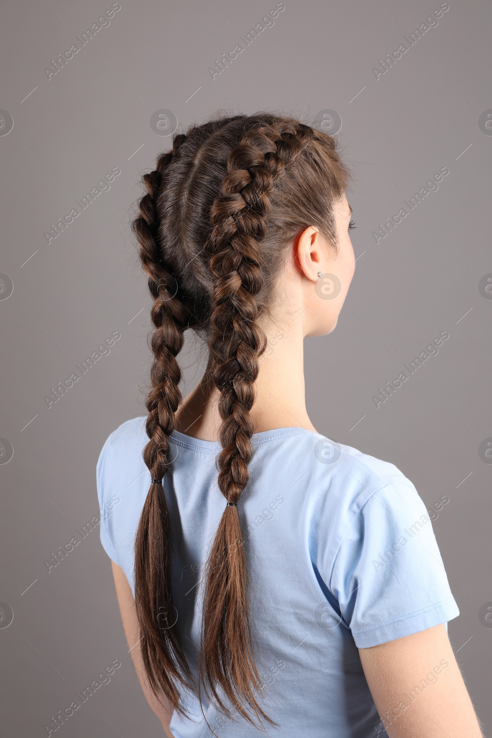 Photo of Woman with braided hair on grey background