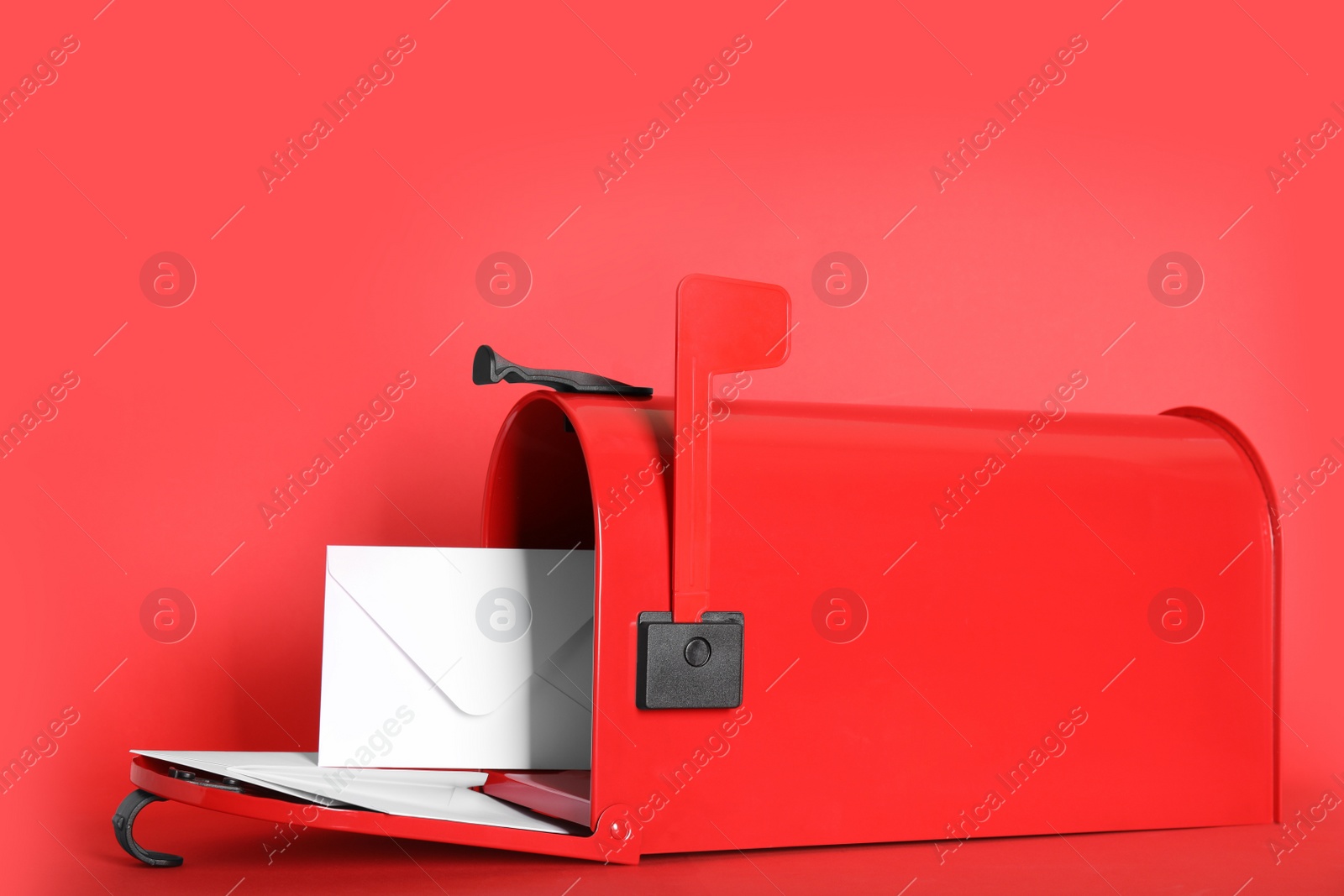 Photo of Open letter box with envelopes on red background