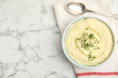 Freshly cooked homemade mashed potatoes with spoon and napkin, top view. Space for text