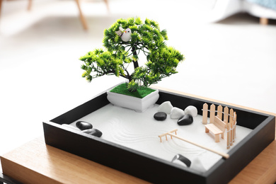 Photo of Beautiful miniature zen garden on wooden table indoors