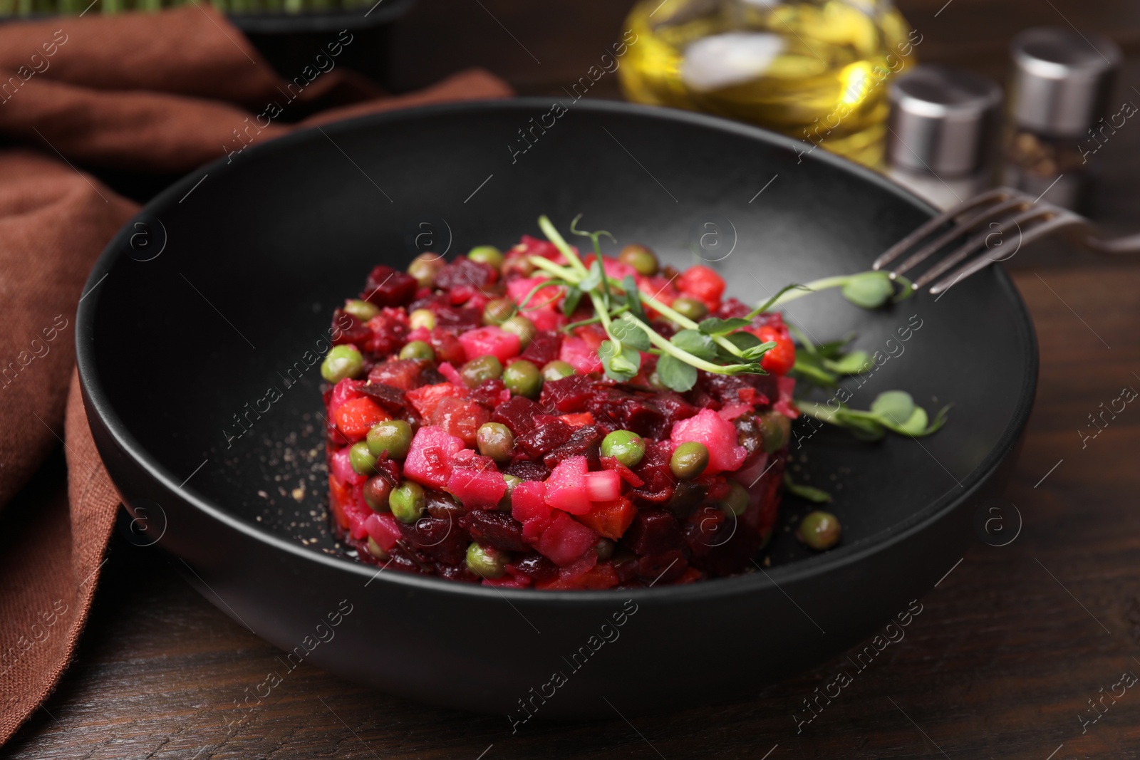 Photo of Delicious vinaigrette salad on wooden table, closeup