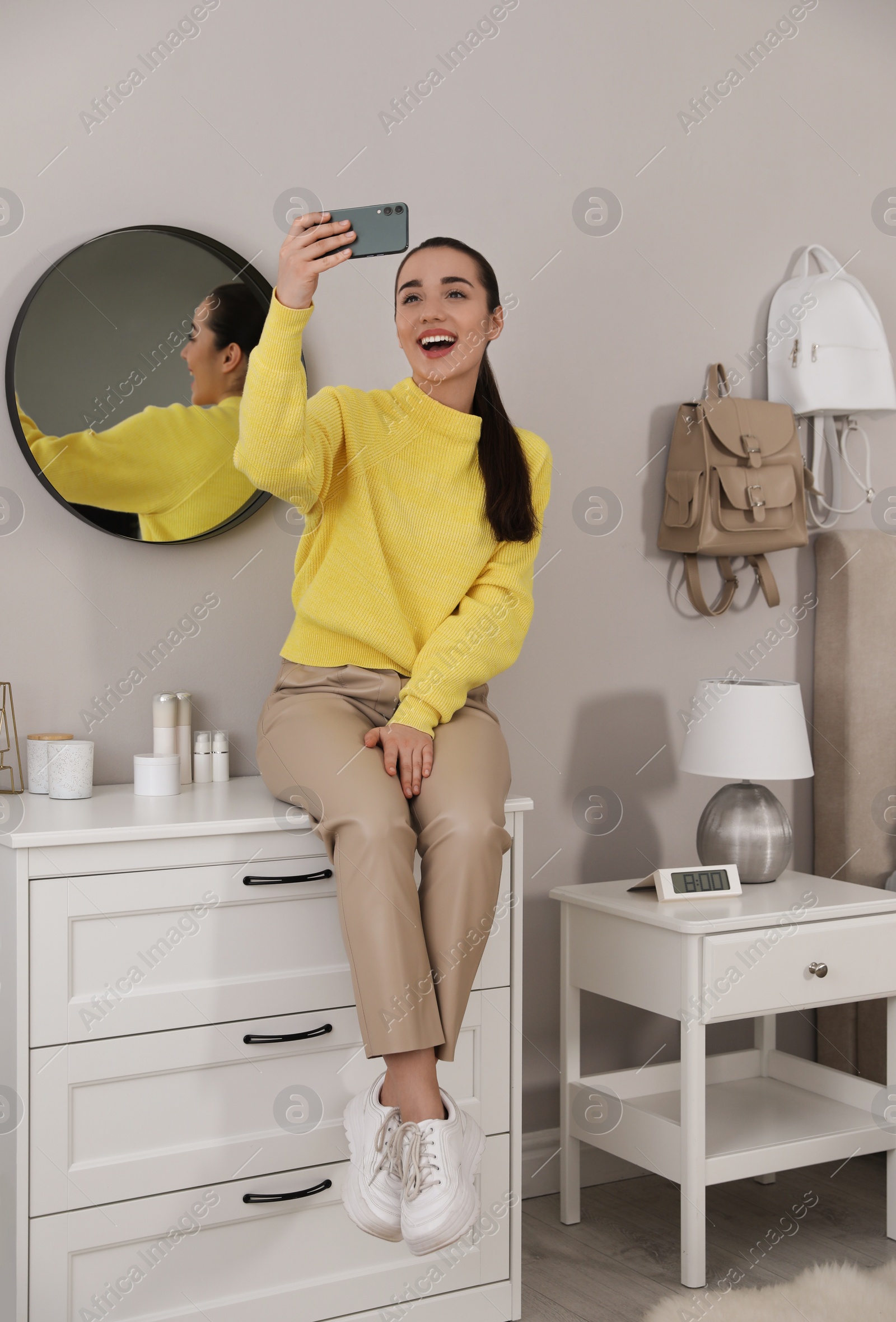 Photo of Young woman taking selfie at home in morning