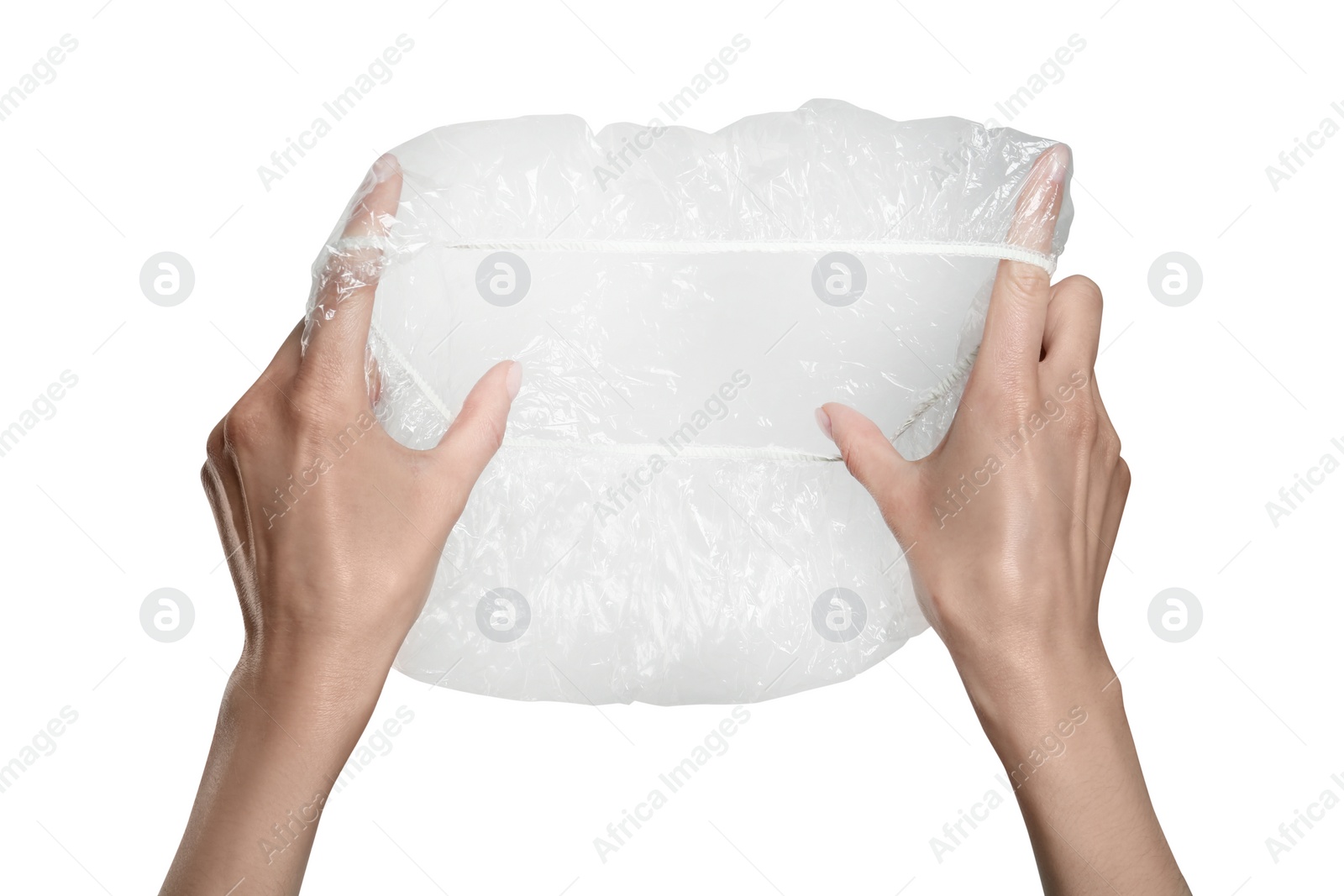 Photo of Woman holding transparent shower cap on grey background, closeup