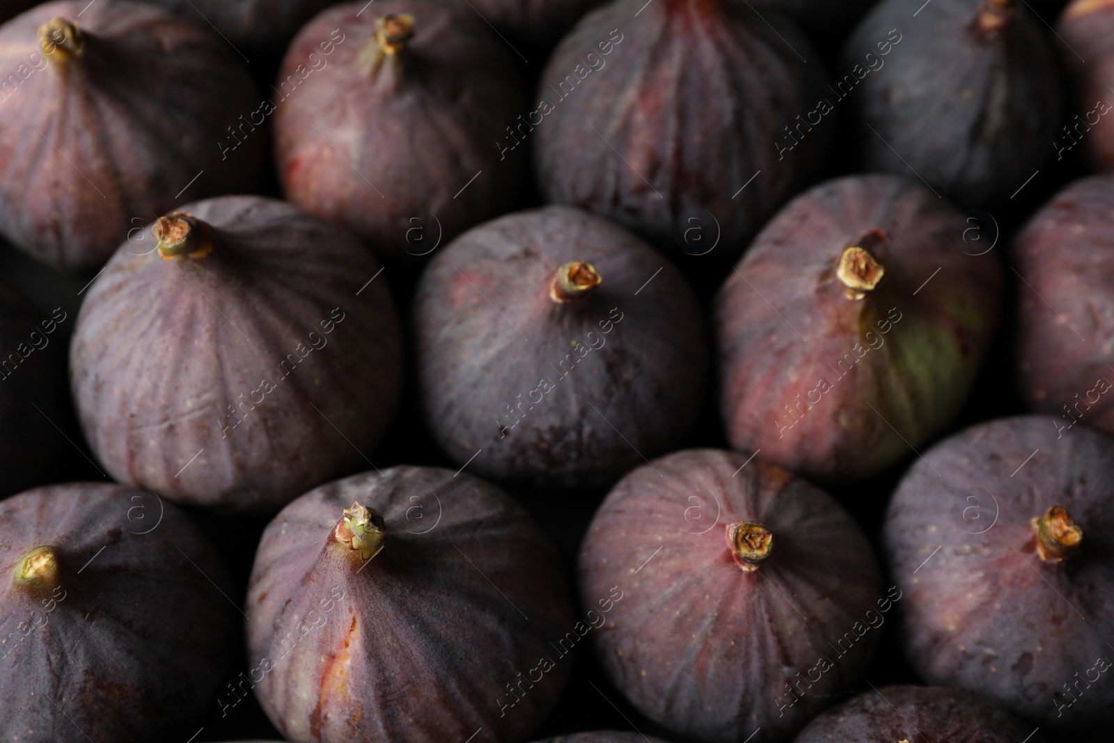 Photo of Tasty raw purple figs as background, closeup