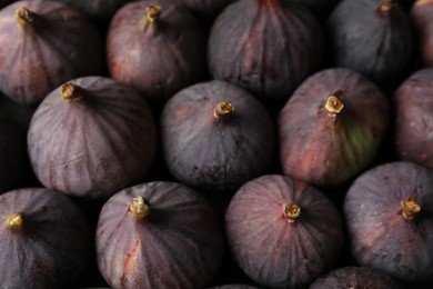 Tasty raw purple figs as background, closeup