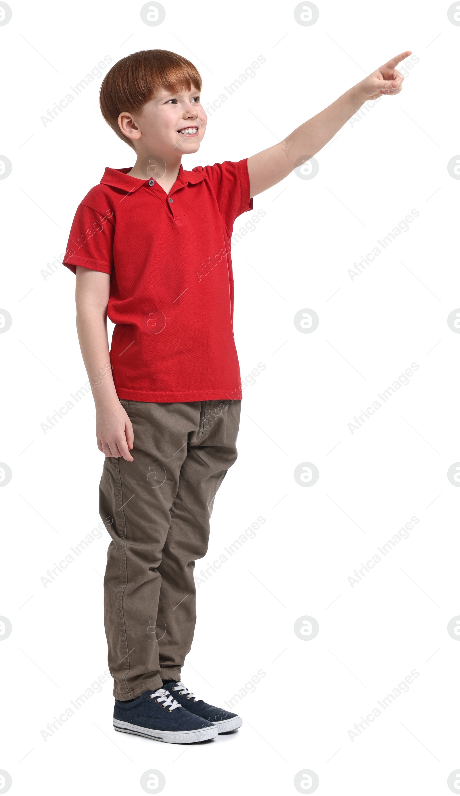 Photo of Little boy pointing at something on white background