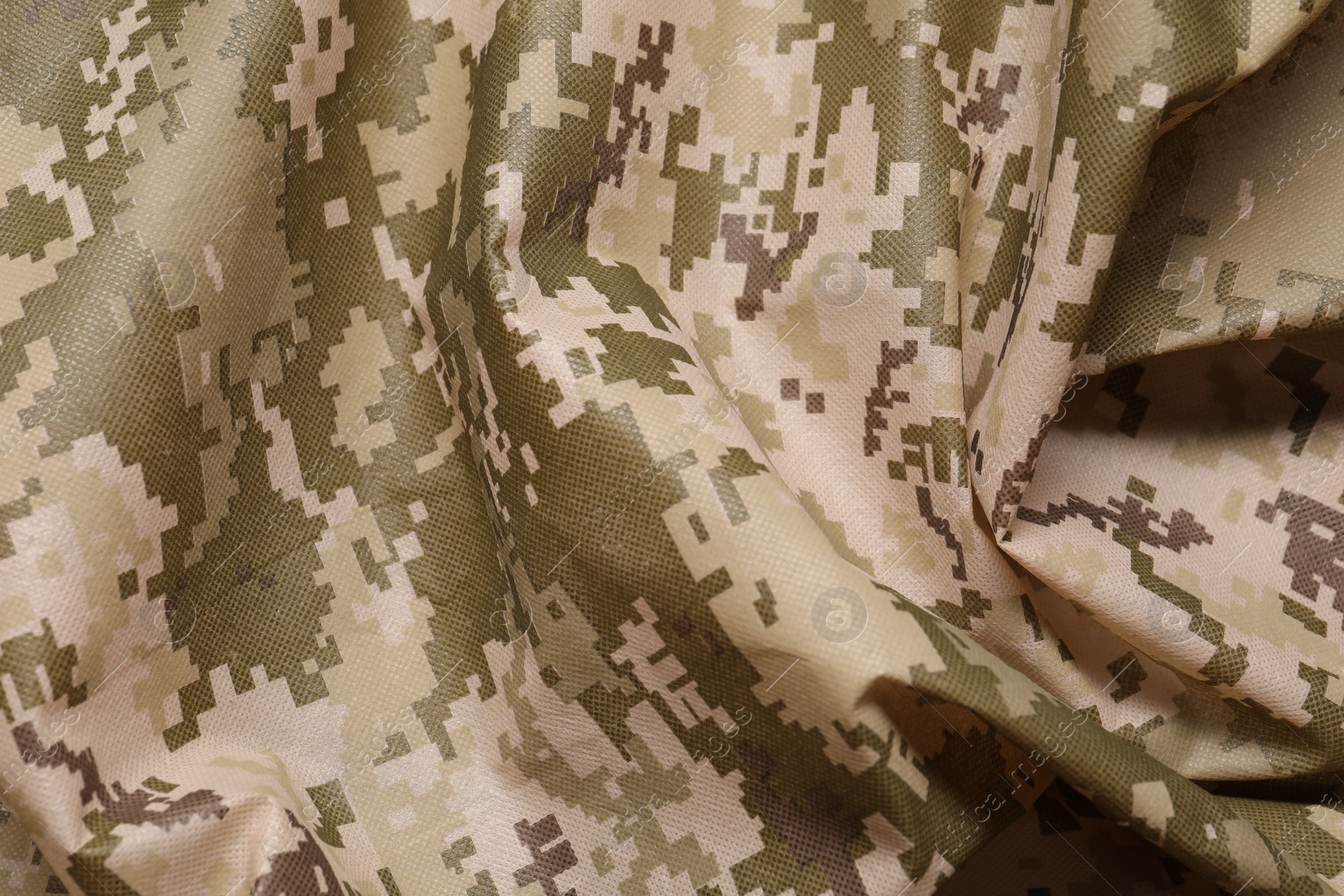 Photo of Texture of crumpled camouflage fabric as background, top view