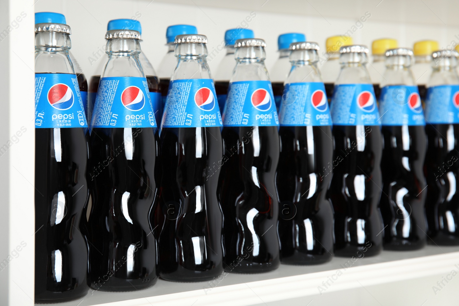 Photo of MYKOLAIV, UKRAINE - FEBRUARY 10, 2021: Bottles of Pepsi on white shelf