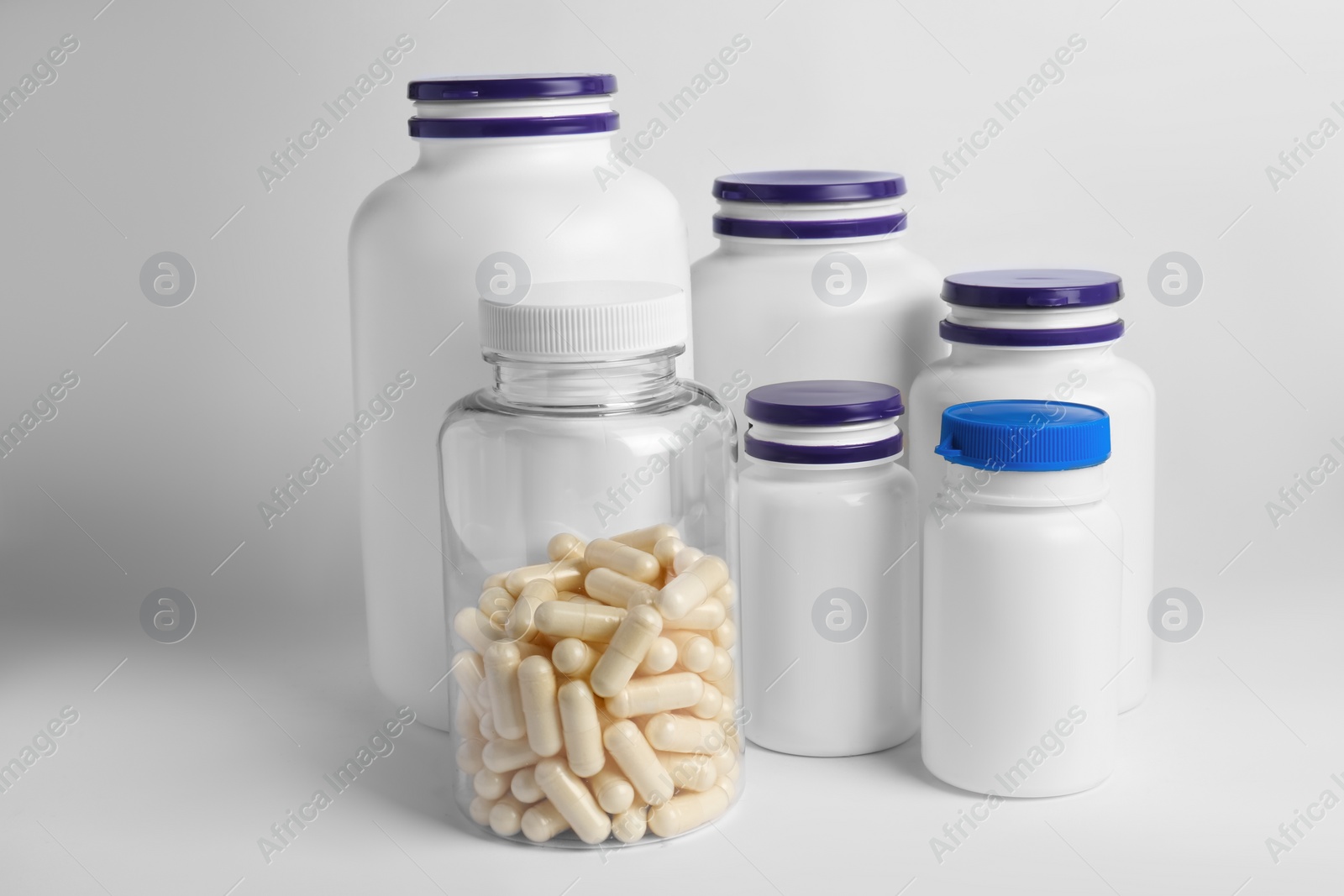 Photo of Many different medicine bottles on white background. Medicament