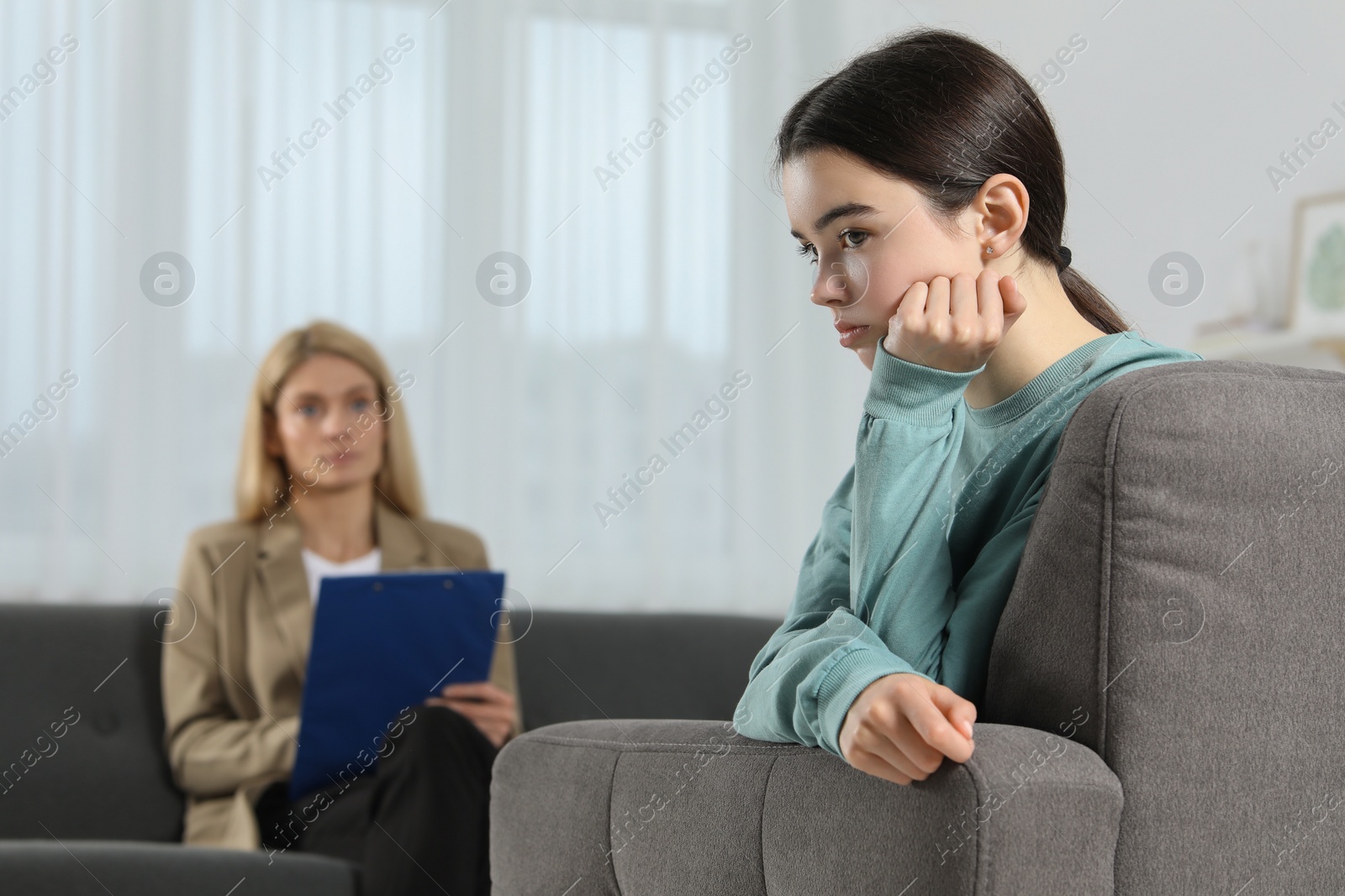 Photo of Psychologist working with teenage girl in office. Teenager problems